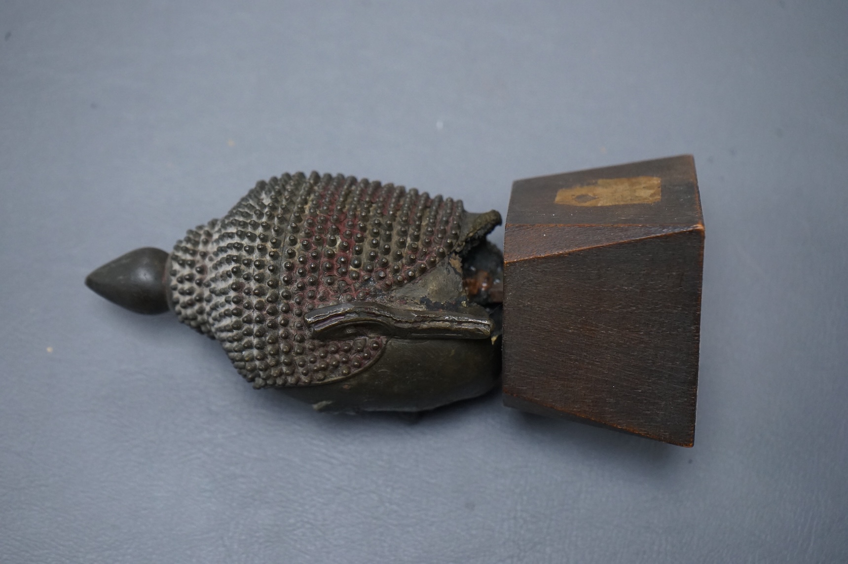 A 17th/18th century Thai, Ayuthia style, bronze head on wooden stand - 14cm high including stand.